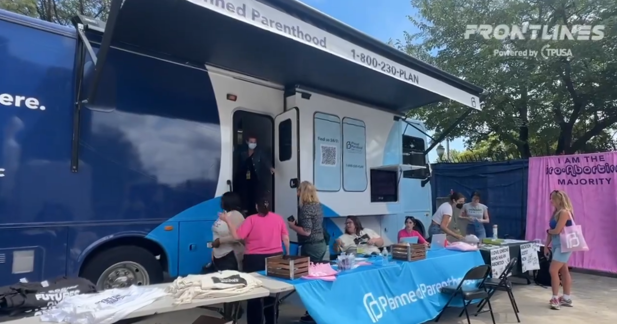 Pro-life activists offer diapers outside Planned Parenthood’s mobile abortion clinic at the DNC.