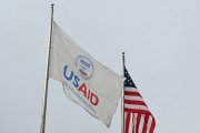 A USAID and American flag fly before Congressional Democrats hold news conference outside of United States Agency for International Development (USAID) headquarters in Washington, DC, on February 3, 2025. US Secretary of State Marco Rubio said Monday he had been put in charge of the US aid agency, saying he would stop its 