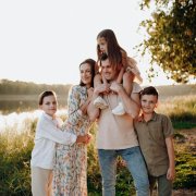 Familia formada por padre, madre y tres hijos, uno de ellos en hombros de su padre