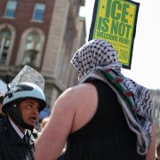 Protester argues with police at anti-Israel protest.