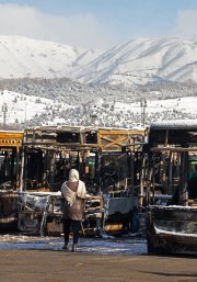 Buses that were burnt at a depot during recent public protests, in Tehran on January 21, 2026