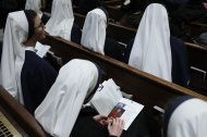 A nun looks through the program of the Solemn Vespers evening prayer at St. Patrick's Cathedral in New York