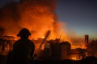 Un bombero lucha contra el incendio Norte Fire mientras este arrasa una casa en San Juan Capistrano, California