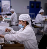 Workers package rabies vaccine at a lab at the Yisheng Biopharma company, where researchers are trying to develop a vaccine for the COVID-19 coronavirus, in Shenyang, in China's northeast Liaoning province, on June 9, 2020. China has mobilised its army and fast-tracked tests in the global race to find a coronavirus vaccine, and is involved in several of the dozen or so international clinical trials currently under way. (Photo by NOEL CELIS / AFP)