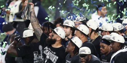 Seattle Seahawks' players celebrate with the Vince Lombardi Trophy after defeating the New England Patriots during Super Bowl LX at Levi's Stadium in Santa Clara, California on February 8, 2026. (Photo by Patrick T. Fallon / AFP)