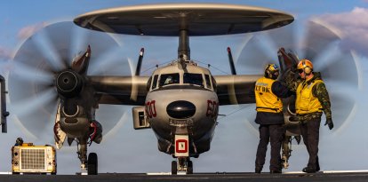 La marina haciendo señales a un avión E‑2D Hawkeye