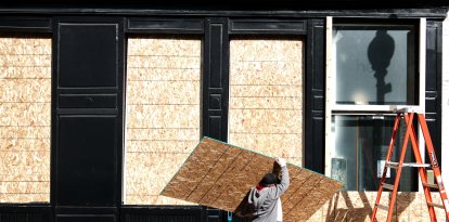 Comercios protegen sus negocios con chapas de madera en los cristales en D.C.