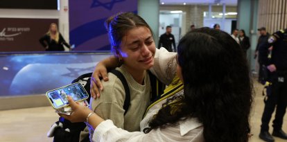 A fan of Maccabi Tel-Aviv is met by a family member at the Ben Gurion International Airport