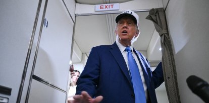 US President Donald Trump talks to the press aboard Air Force One on the way to Morristown Municipal Airport in Morristown, New Jersey, on June 6, 2025. Trump is travelling to his residence and golf club in Bedminster, New Jersey. (Photo by ANDREW CABALLERO-REYNOLDS / AFP)