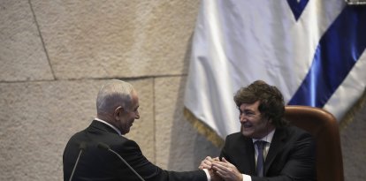 Israel's Prime Minister Benjamin Netanyahu greets Argentina's President Javier Milei in the Knesset, Israel's parliament