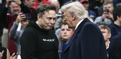 Tesla and SPaceX CEO Elon Musk and US President Donald Trump shake hands as they attend the men's NCAA wrestling competition at the Wells Fargo Center in Philadelphia, Pennsylvania, on March 22, 2025. (Photo by Brendan SMIALOWSKI / AFP) / ALTERNATE CROP