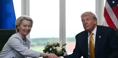 US President Donald Trump (R) shakes hands with European Commission President Ursula von der Leyen (L) after agreeing on a trade deal between the two economies following their meeting, in Turnberry south west Scotland on July 27, 2025, on the third day of his visit to the country, since his second tenure as President began. US President Donald Trump said on July 27, 2025 that he had reached a trade agreement with European Union chief Ursula von der Leyen. "We have reached a deal. It's a good deal for everybody," Trump told reporters after talks with von der Leyen at his golf resort in Turnberry, Scotland. The EU chief also hailed it as a "good deal". (Photo by Brendan SMIALOWSKI / AFP)