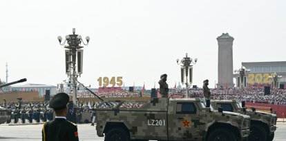 Military vehicles roll during a military parade marking the 80th anniversary of victory over Japan and the end of World War II, in Beijings Tiananmen Square on September 3, 2025. (Photo by GREG BAKER / AFP)
