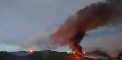 Fire at Fuerte Tiuna, Venezuela's largest military complex, is seen from a distance after a series of explosions in Caracas on January 3, 2026. The United States military was behind a series of strikes against the Venezuelan capital Caracas on Saturday, US media reported. The White House and Pentagon have not commented on the explosions and reports of aircraft over the city. US media outlets CBS News and Fox News reported unnamed Trump administration officials confirming that US forces were involved. (Photo by AFP)