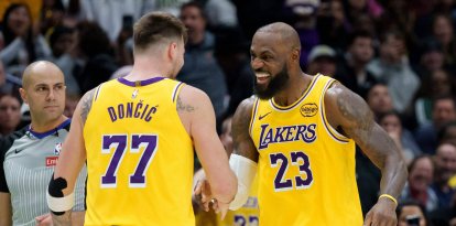 Los Angeles Lakers forward/guard Luka Dončić (77) celebrates a three point basket with forward LeBron James (23) against the New Orleans Pelicans during the second half of an NBA basketball game in New Orleans, Tuesday, Jan. 6, 2026. (AP Photo/Matthew Hinton)