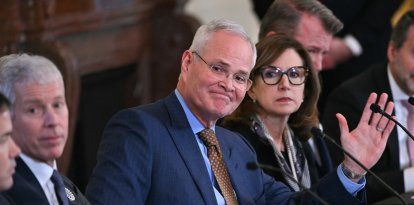 ExxonMobil CEO Darren Woods (C) attends a meeting with US President Donald Trump and oil company executives in the East Room of the White House in Washington, DC on January 9, 2026. President Trump is aiming to convince oil executives to support his plans in Venezuela, a country whose energy resources he says he expects to control for years to come. US forces seized Venezuelan president Nicolas Maduro in a sweeping military operation on January 3, with Trump making no secret that control of Venezuela's oil was at the heart of his actions. (Photo by Brendan SMIALOWSKI / AFP)