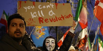 An anti-Iranian regime protester holds up a placard (Files)