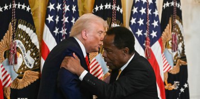 US President Donald Trump shakes hands with Leo Terrell