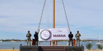 Mexican Navy soldiers standing next to seized packages of cocaine