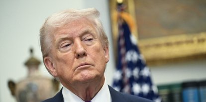 US President Donald Trump looks on as he makes an announcement in the Roosevelt Room of the White House in Washington, DC on February 12, 2026. President Donald Trump on Thursday revoked a landmark scientific finding that underpins US regulations aimed at curbing planet-warming pollution, marking the administration's most far-reaching rollback of climate policy to date. (Photo by SAUL LOEB / AFP)