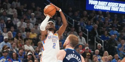 El base de los Oklahoma City Thunder, Shai Gilgeous-Alexander (2), lanza a canasta por encima del base de los Minnesota Timberwolves, Donte DiVincenzo (0), durante la primera mitad de un partido de baloncesto de la NBA, el domingo 15 de marzo de 2026, en Oklahoma City.