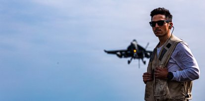 A U.S. Sailor assigned to Carrier Air Wing 8 serves as a landing signal officer on the flight deck of USS Gerald R. Ford (CVN 78), as an aircraft approaches for a landing while underway, March 17, 2026. (U.S. Navy photo)