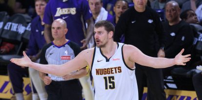 Los Ángeles, California, EE. UU.: Nikola Jokic, con el dorsal n.º 15 de los Denver Nuggets, discute una decisión arbitral durante el partido de la temporada regular de la NBA contra los Los Angeles Lakers, celebrado el sábado 14 de marzo de 2026 en el Crypto.com Arena de Los Ángeles, California. Los Lakers vencen a los Nuggets por 127 a 125.
