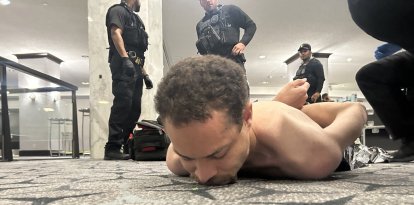 This image released by US President Donald Trump via his Truth Social account (@realDonaldTrump) shows a person he claims to be the alleged suspect in the shooting incident at the White House Correspondents Dinner on the ground after being apprehended on April 25, 2026. US Secret Service agents bundled Donald Trump from the stage as shots rang out Saturday evening at a media gala, in what the president later described as an attack by a "would-be assassin." Armed guards opened fire at the gunman who charged through security screening just outside the ballroom of the hotel, where Trump, First Lady Melania Trump, many senior government officials and hundreds of other black-tie guests had gathered. (Photo by @REALDONALDTRUMP / TRUTH SOCIAL / AFP) / RESTRICTED TO EDITORIAL USE - MANDATORY CREDIT "AFP PHOTO /  @REALDONALDTRUMP - TRUTH SOCIAL " - HANDOUT - NO MARKETING NO ADVERTISING CAMPAIGNS - DISTRIBUTED AS A SERVICE TO CLIENTS