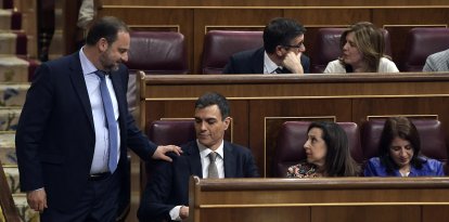 Socialist MP's Jose Luis Abalos Pedro Sanchez (L) greets the leader of Spanish Socialist Party PSOE, Pedro Sanchez during a no-confidence motion tabled by Spanish Socialist party at the Lower House of the Spanish Parliament in Madrid on May 31, 2018. Spanish Prime Minister Mariano Rajoy faces a no-confidence vote at the end of the week after a court ruled his governing Popular Party benefited for years from a large kickbacks-for-contracts scheme. (Photo by OSCAR DEL POZO / AFP)