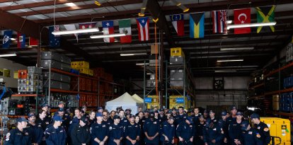 Members of the County of Los Angeles Fire Departments international urban search and rescue team (USA-2) prepare to leave for Venezuela, in Pacoima, California on June  25, 2026. The County of Los Angeles Fire Departments international urban search and rescue team (USA-2) will departs in response to the Venezuela earthquakes. 71 crew members alongside 6 dogs will be sent to Venezuela to aid in search and rescue efforts. The United States said Thursday it was mobilizing $150 million in aid for Venezuela after two powerful earthquakes killed at least 188 people and left hundreds injured, as rescuers around the world raced to provide help. (Photo by Blake Fagan / AFP)