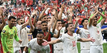 Moroccan players celebrate after their victory over Canada/ Ronaldo Schemidt