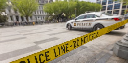Police car vehicle of United States Secret Service and POLICE LINE- DO NOT CROSS ribbon.