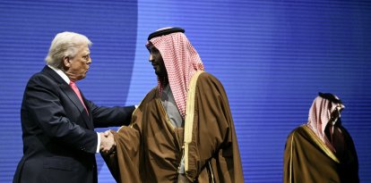 US President Donald Trump shakes hands with Crown Prince and Prime Minister of the Kingdom of Saudi Arabia Mohammed bin Salman at the US-Saudi Investment Forum at the John F. Kennedy Center for the Performing Arts in Washington, DC on November 19, 2025. (Photo by Brendan SMIALOWSKI / AFP)