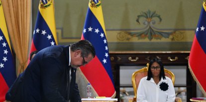 El presidente de Chevron Venezuela, Mariano Vela, firma un documento junto a la presidenta del régimen interino de Venezuela, Delcy Rodríguez, el 13 de abril de 2026.
