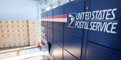 USPS Smart Lockers for package pickup stand in the lobby of the United States Postal Service (USPS)