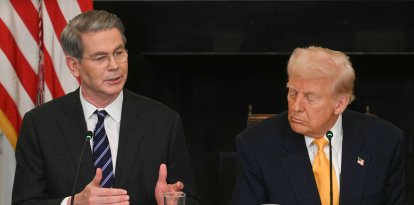 US President Donald Trump listen to US Secretary of Treasury Scott Bessent