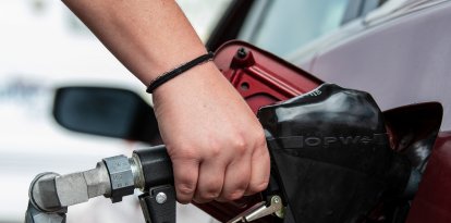 Un cliente utiliza la boquilla de un surtidor de combustible para llenar el tanque de un automóvil en una gasolinera en Santaquin, Utah, el 31 de agosto de 2026.