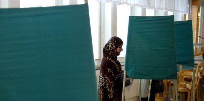A Muslim woman casts her vote at a polling station during general elections in Stockholm in 2010
