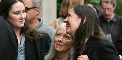 Patrice Failor (C), wife of former FBI director James Comey, walks with daughters Maurene Comey (R) and Claire Comey (L)