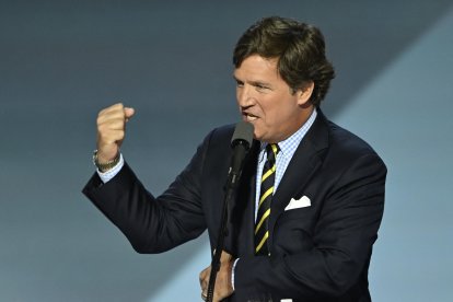 US political commentator Tucker Carlson speaks during the last day of the 2024 Republican National Convention at the Fiserv Forum in Milwaukee, Wisconsin, on July 18, 2024. - Donald Trump will get a hero's welcome Thursday as he accepts the Republican Party's nomination to run for US president in a speech capping a convention dominated by the recent attempt on his life. (Photo by ANDREW CABALLERO-REYNOLDS / AFP)