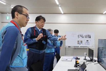This handout photo taken on September 9, 2024 and received from Tokyo Electric Power Company (TEPCO) on September 10, 2024 shows TEPCO staff members checking in the operations room as the push pipes used for the removal of radioactive debris are rearranged in the correct order, at TEPCO's Fukushima Daiichi nuclear power plant in Okuma, Fukushima prefecture. - A difficult operation to remove a small amount of radioactive debris from Japan's stricken Fukushima nuclear plant began on September 10, after technical issues suspended an earlier attempt. (Photo by Handout / TEPCO / AFP) / -----EDITORS NOTE --- RESTRICTED TO EDITORIAL USE - MANDATORY CREDIT "AFP PHOTO / TOKYO ELECTRIC POWER COMPANY HOLDINGS, INC. (TEPCO) " - NO MARKETING - NO ADVERTISING CAMPAIGNS - DISTRIBUTED AS A SERVICE TO CLIENTS