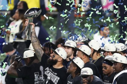 Seattle Seahawks' players celebrate with the Vince Lombardi Trophy after defeating the New England Patriots during Super Bowl LX at Levi's Stadium in Santa Clara, California on February 8, 2026. (Photo by Patrick T. Fallon / AFP)