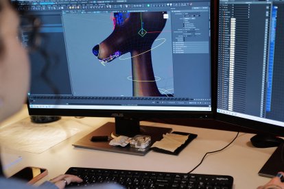 An employee works on computers at the office of Illogic Studios in Montpellier, southtern France, on December 12, 2025. At a time when multinationals are being criticized for using artificial intelligence in their advertising, a Christmas ad created by a French animation studio for Intermarché is crossing borders on social media, racking up more than 20 million views as of December 10, according to the head of the French retailer. (Photo by Sylvain THOMAS / AFP)