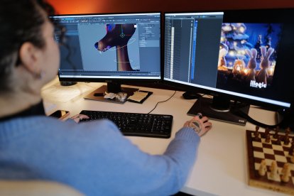 An employee works on computers at the office of Illogic Studios in Montpellier, southtern France, on December 12, 2025. At a time when multinationals are being criticized for using artificial intelligence in their advertising, a Christmas ad created by a French animation studio for Intermarché is crossing borders on social media, racking up more than 20 million views as of December 10, according to the head of the French retailer. (Photo by Sylvain THOMAS / AFP)