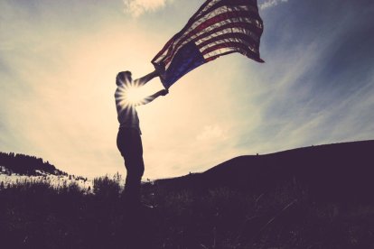 A man waves a US flag.