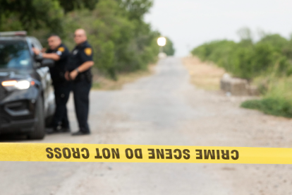 Image with police officers and crime scene tape.