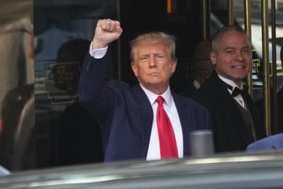 Former President Donald Trump gestures with a fist before leaving Trump Tower, Tuesday, April 4, 2023 in New York after to face charges related to hush money payments.