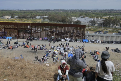 Migrants stuck between the primary and secondary fencing at the Tijuana-San Diego border
