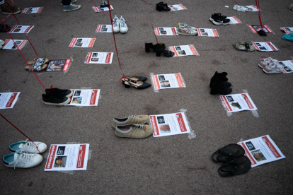 Dozens of shoes and posters put up by the Israeli community in Barcelona commemorate the abductions and children killed since October 7th