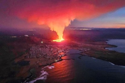 TOPSHOT - Billowing smoke and flowing lava are seen in this Icelandic Department of Civil Protection and Emergency Management , January 14, 2024, handout image during an volcanic eruption on the outskirts of the evacuated town of Grindavik, western Iceland.